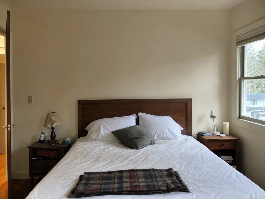 Bedroom with bare painted walls before wallpaper installation